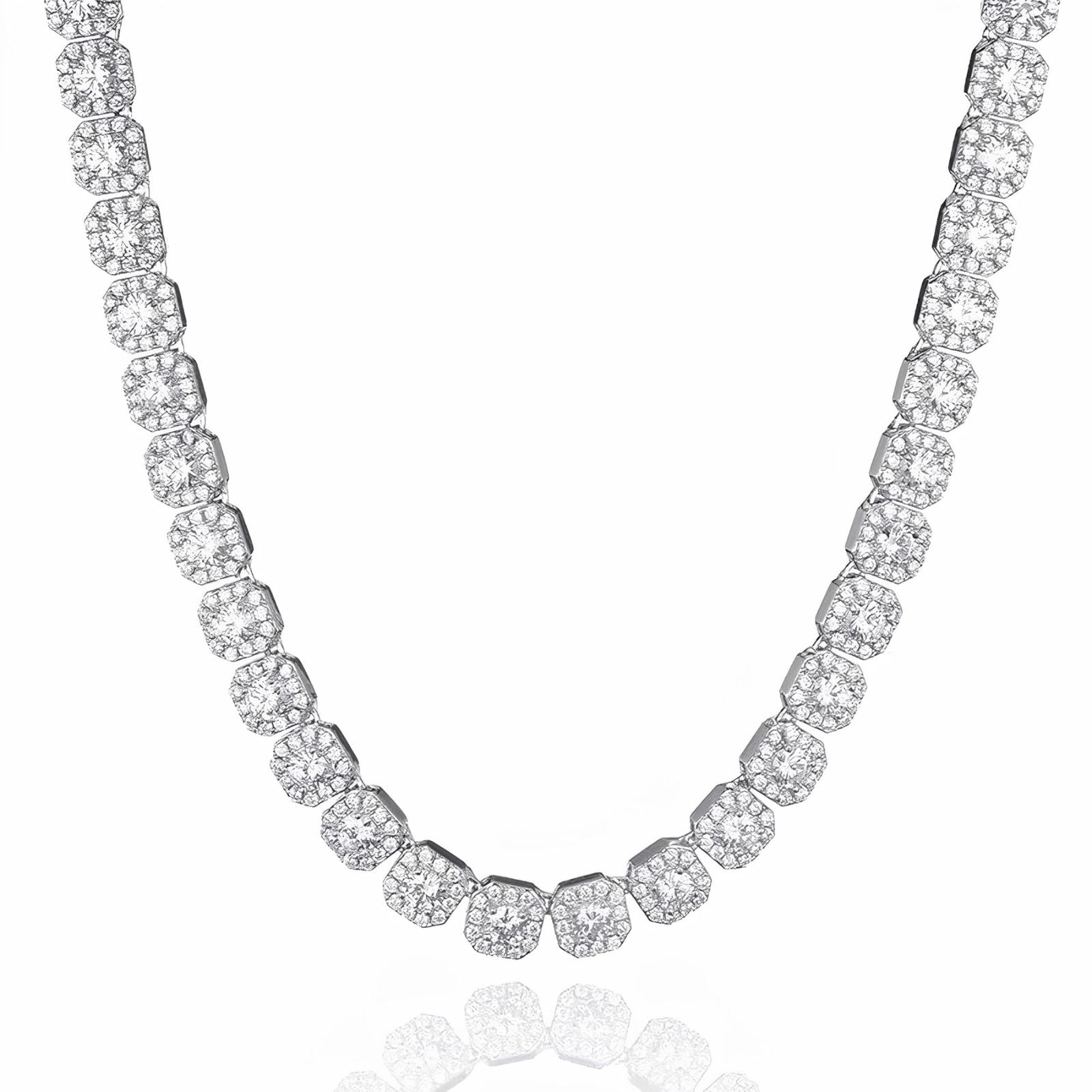 A silver-toned tennis necklace paved with round and cushion-cut clear stones, displayed on a clean white background with a subtle reflection below.