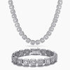A silver-toned jewelry set featuring a matching necklace and bracelet, both adorned with round-cut clear cubic zirconia stones in a linked design, displayed on a clean white background.