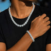 A close-up of a person wearing a sparkling cubic zirconia tennis chain and matching bracelet, with the necklace clearly displayed against the neck and wrist.