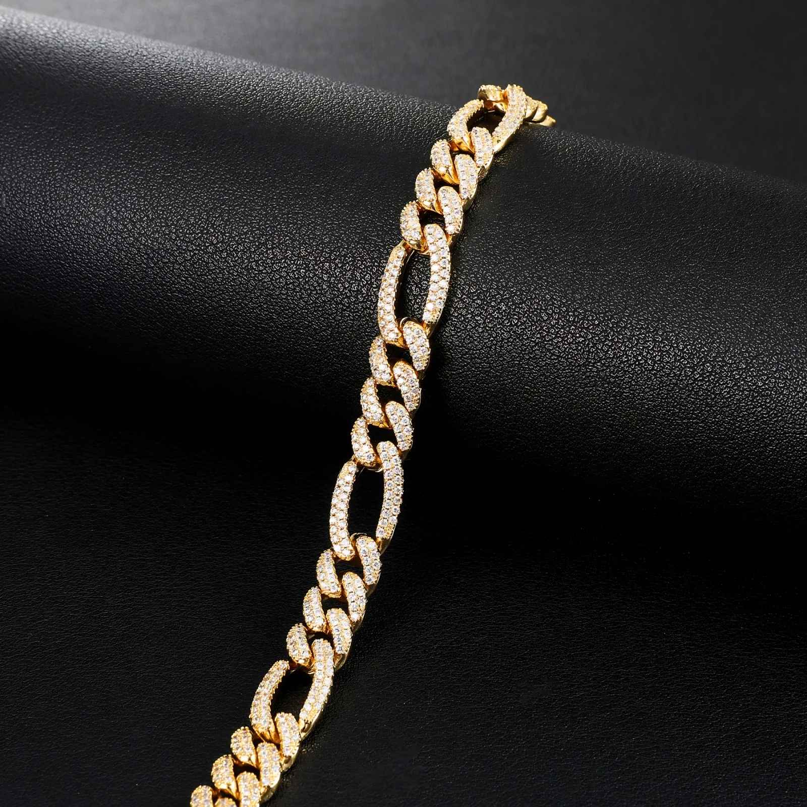 Gold chain bracelet on a black fabric background