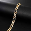 Gold chain bracelet on a black fabric background