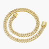 A gold-toned Cuban link chain paved with small clear stones, coiled on a light gray background.