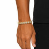 Gold clustered tennis bracelet worn on wrist