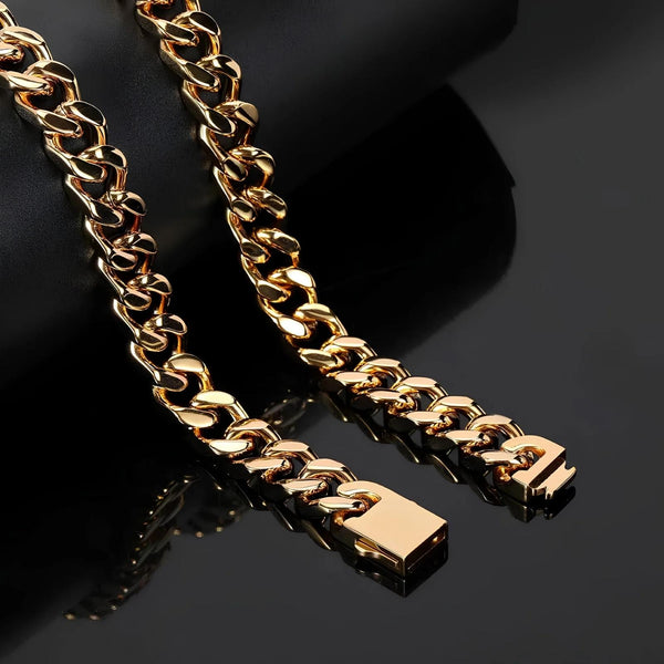 A close-up of a thick gold Cuban link chain necklace draped over a black display stand on a glossy black surface.