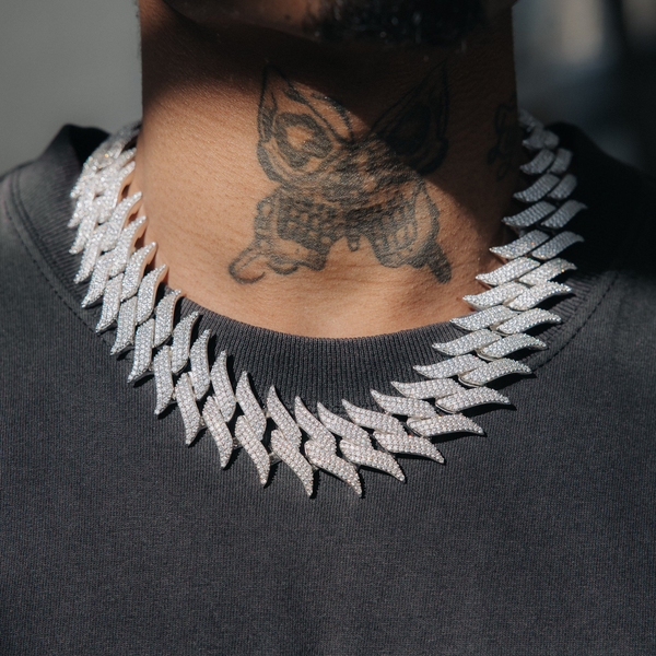 Model wearing 16mm iced gold spiked Cuban chain necklace