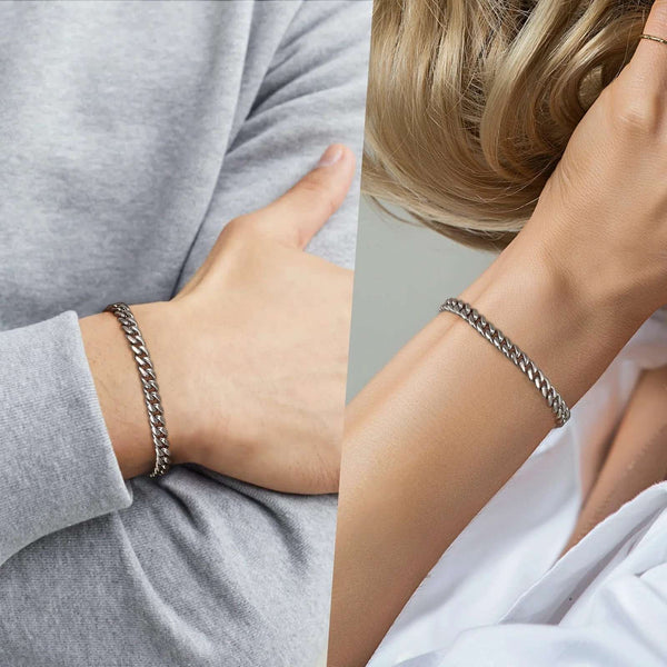 A close-up split view showing a silver-toned chain bracelet worn on a person's wrist, with one side showing the bracelet on a gray long-sleeve top and the other on white clothing.