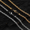 Two rope chains, one gold and one silver, on a dark textured surface.