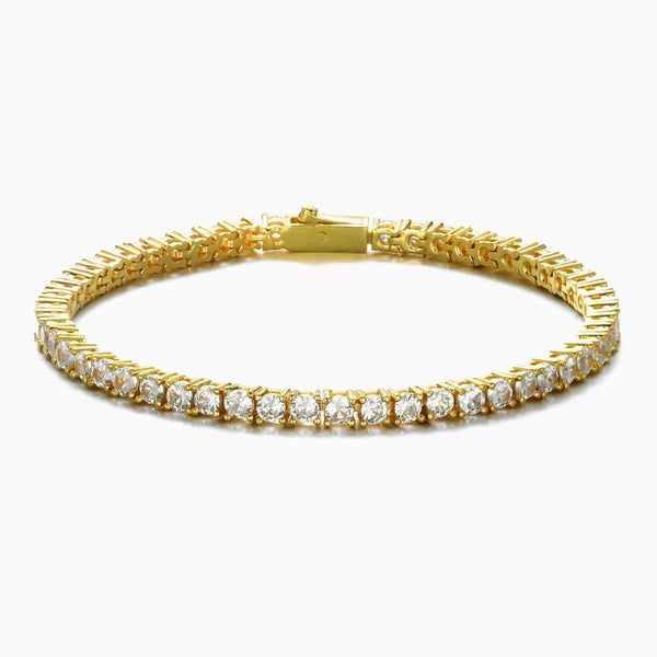 A gold tennis bracelet featuring a row of clear round-cut cubic zirconia, displayed on a clean white background.