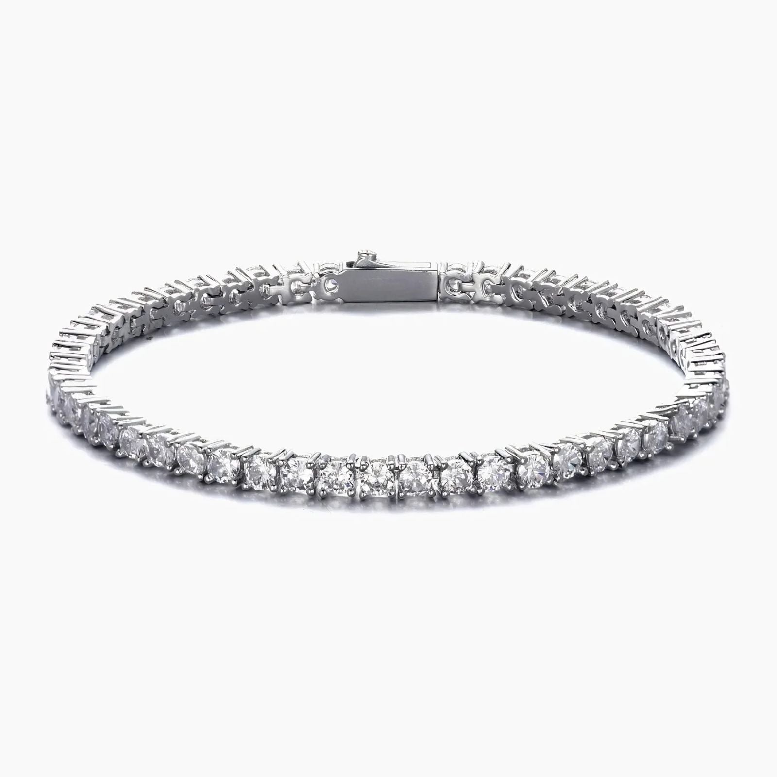 A silver tennis bracelet with a continuous row of round-cut clear cubic zirconia in a prong setting, shown against a plain white background.