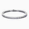 A silver tennis bracelet with a continuous row of round-cut clear cubic zirconia in a prong setting, shown against a plain white background.