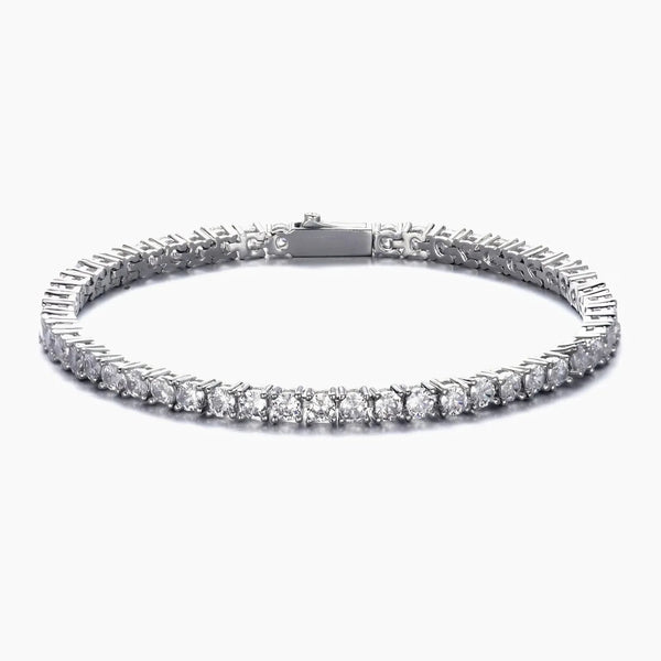 A silver tennis bracelet with a continuous row of round-cut clear cubic zirconia in a prong setting, shown against a plain white background.