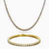 A gold tennis necklace and matching gold tennis bracelet, both adorned with clear cubic zirconia stones, displayed on a clean white background.