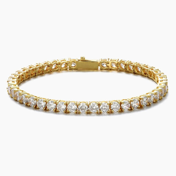 A gold tennis bracelet featuring a continuous row of round-cut clear cubic zirconia in a prong setting, shown against a plain light gray background.