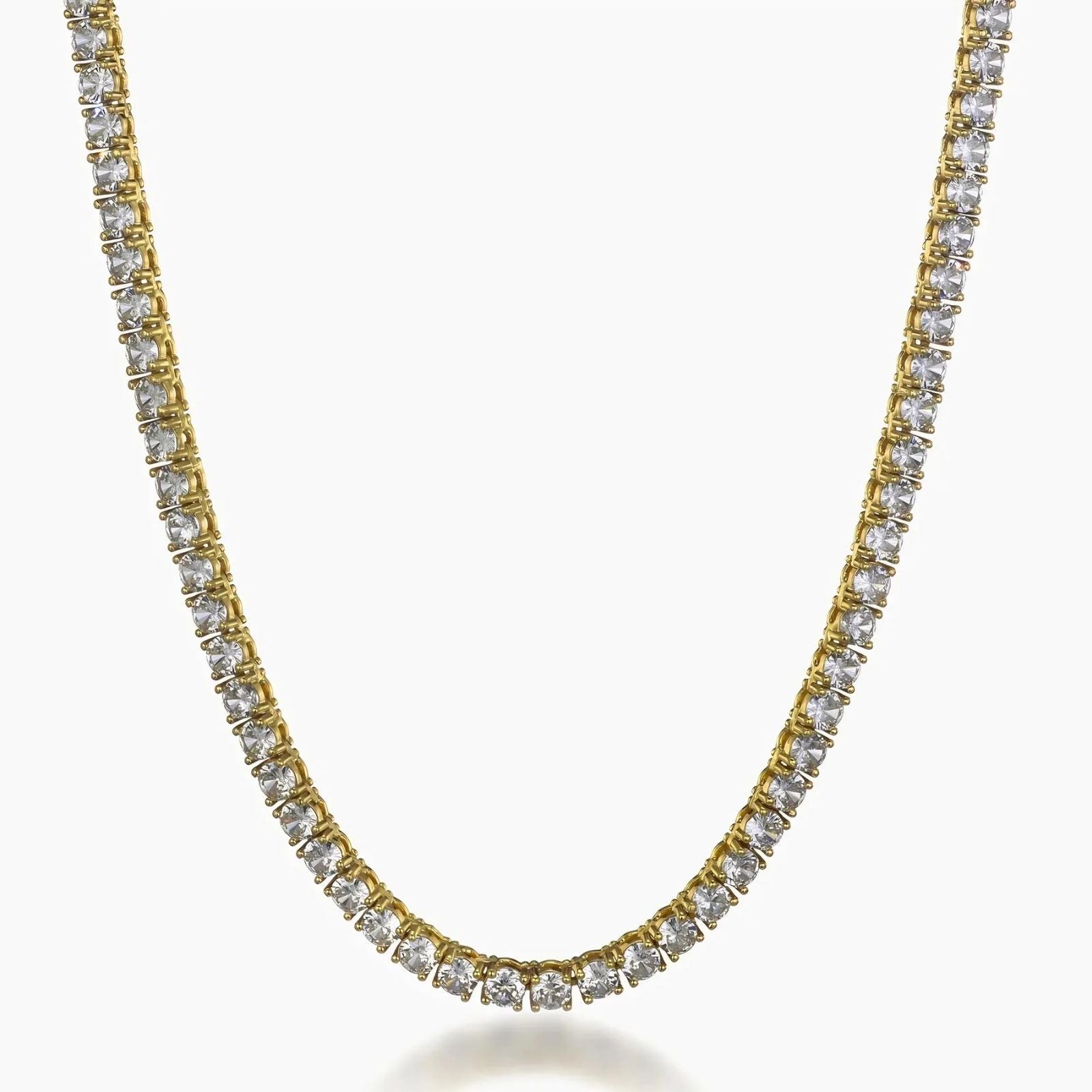 A gold tennis necklace paved with clear round-cut cubic zirconia, shown against a plain white background.