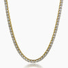 A gold tennis necklace paved with clear round-cut cubic zirconia, shown against a plain white background.