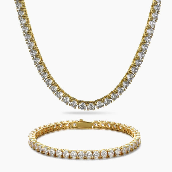 A gold tennis necklace and matching bracelet set, both paved with clear round cubic zirconia, displayed on a clean white background.