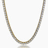 A gold tennis necklace with clear round-cut cubic zirconia, shown on a plain light gray background.