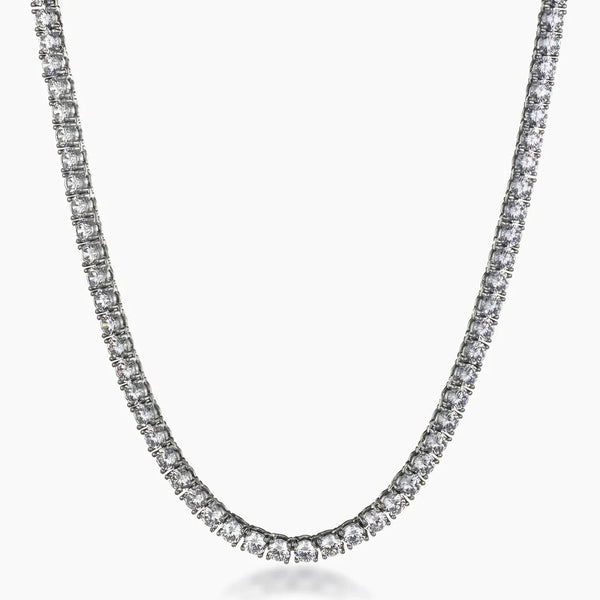 A tennis-style necklace with a continuous row of clear cubic zirconia in a silver-toned setting, shown against a plain light gray background.