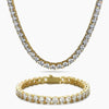 A gold tennis necklace and matching bracelet set, both adorned with clear round-cut cubic zirconia, displayed on a clean white background.
