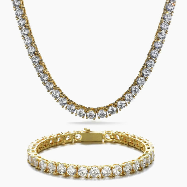 A gold tennis necklace and matching bracelet set, both adorned with clear round-cut cubic zirconia, displayed on a clean white background.