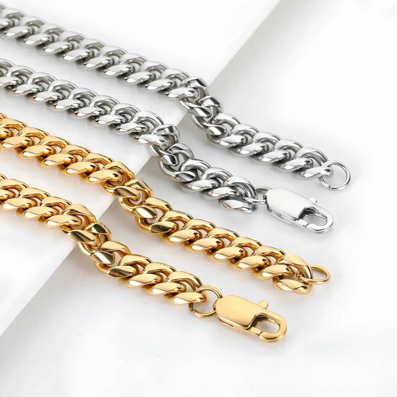 Two gold and one silver chain on a white background