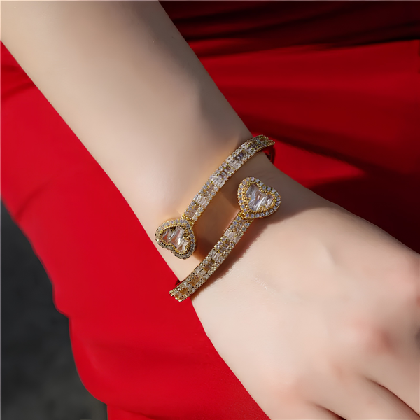 Model wearing 6mm iced baguette heart cuff bracelet in gold