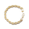 A gold-toned braided chain bracelet paved with small clear stones, shown on a plain white background. The bracelet has a lobster clasp closure and a small round charm.
