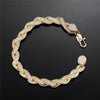 Gold bracelet with cubic zirconia accents on a black background