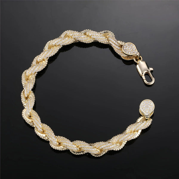 Gold bracelet with cubic zirconia accents on a black background