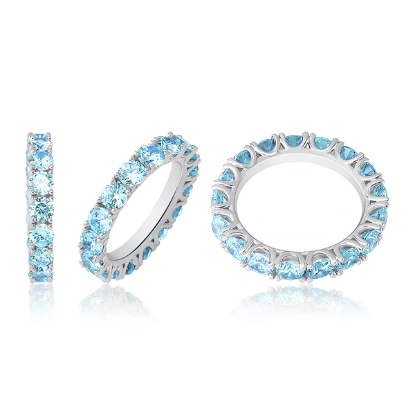 Multiple views of silver baby blue tennis ring with blue stones.
