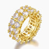 A gold-plated eternity ring featuring multiple round clear cubic zirconia stones set in a prong setting, shown on a light gray background.