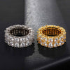Two double row rings, one silver and one gold, on a black textured surface.