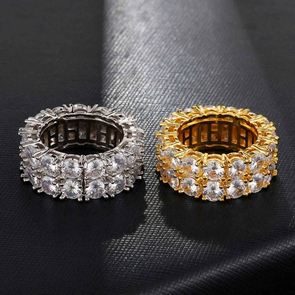 Two double row rings, one silver and one gold, on a black textured surface.