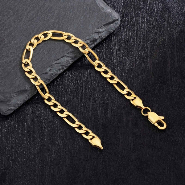 Gold chain bracelet on a black surface