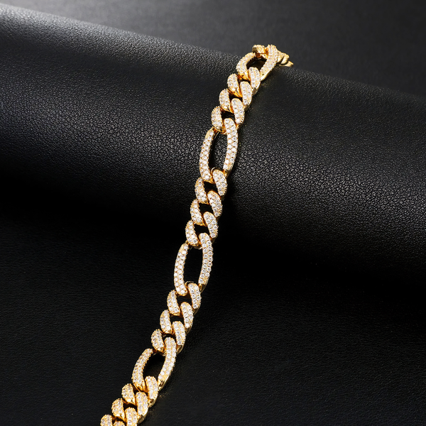 Gold iced Figaro bracelet with cubic zirconia stones displayed on a black background.