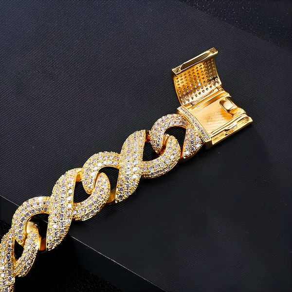 Close-up of the box clasp on a gold iced prong bracelet with cubic zirconia stones on a black background.