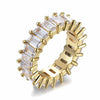 A gold eternity-style ring with clear rectangular baguette cubic zirconia, shown on a clean white background.