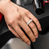 Hand wearing a baguette tennis ring with a blurred background