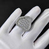 Silver ring with cubic zirconia on a white gloved hand against a black background