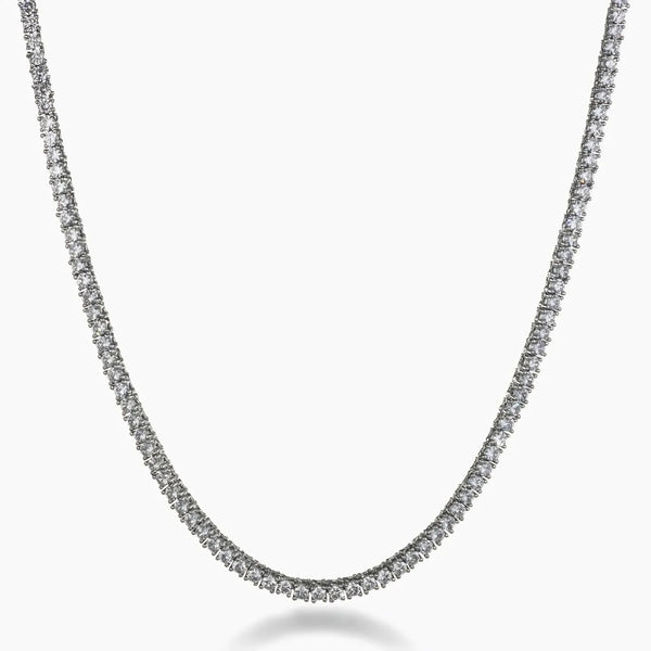 A silver-toned tennis chain necklace paved with small clear stones, shown against a plain white background.