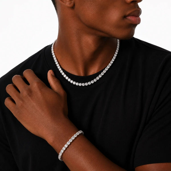 Person wearing a tennis necklace and bracelet on a black background