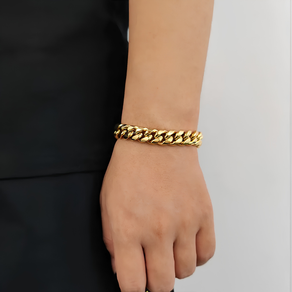 Close-up of a men's gold Miami Cuban bracelet worn on the wrist, showcasing the polished curb links and premium finish.