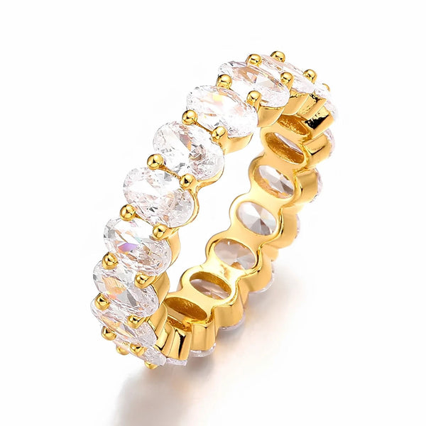 Gold ring with clear cubic zirconia on a white background