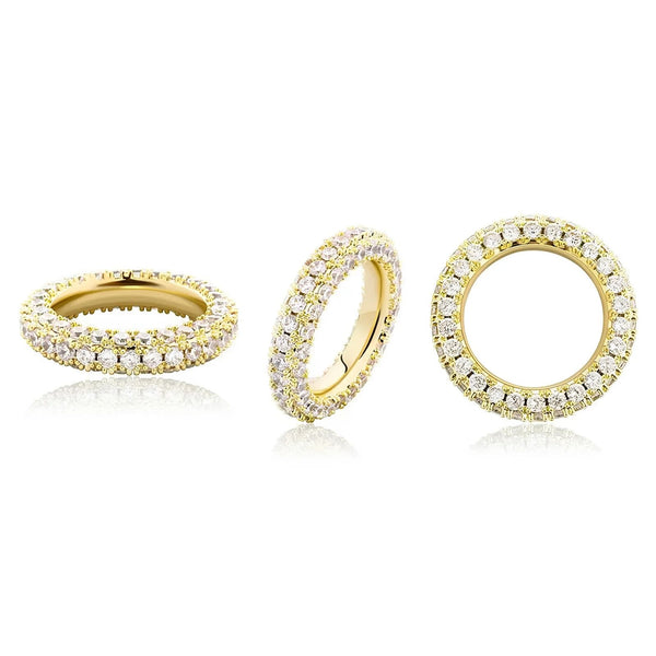 A gold ring shown from three angles on a white background. The ring is paved with small clear cubic zirconia stones.