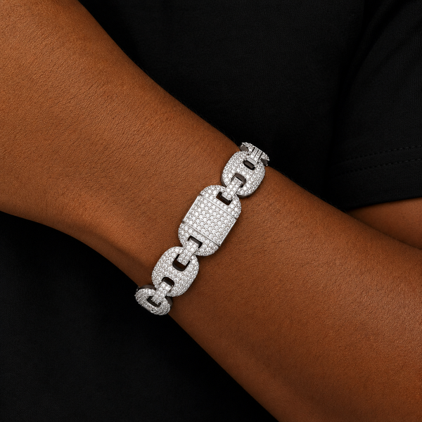 Silver iced link bracelet worn on wrist with black clothing background