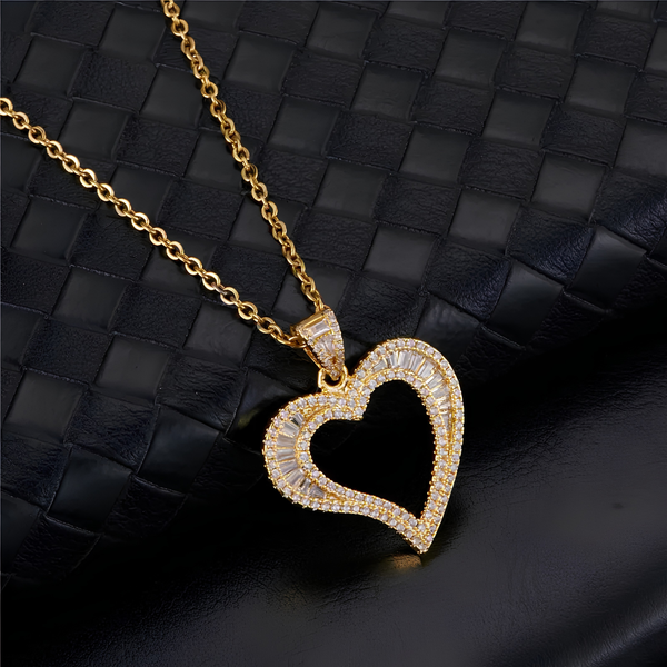 Gold iced open heart pendant necklace displayed on black surface