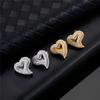 Gold and silver pavé heart stud earrings side by side