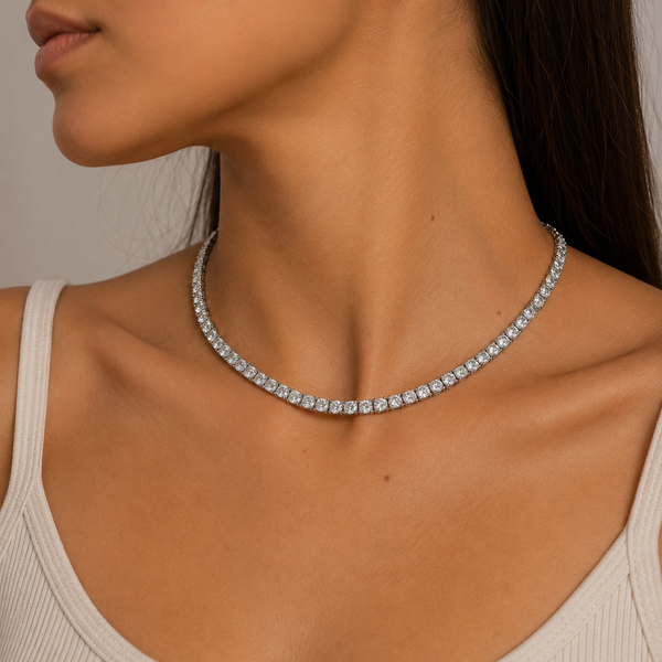 Woman wearing a 4mm silver tennis chain necklace with cubic zirconia stones.