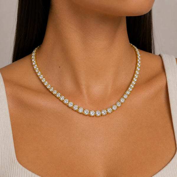 Woman wearing a 5mm gold tennis chain necklace featuring cubic zirconia stones.