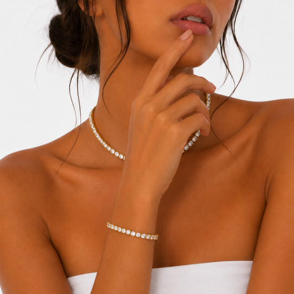 Woman wearing a matching 5mm gold tennis chain and bracelet set